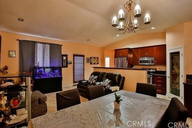 dining space featuring an inviting chandelier and vaulted ceiling