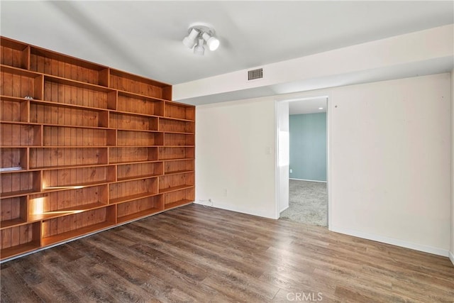 unfurnished room featuring dark hardwood / wood-style flooring