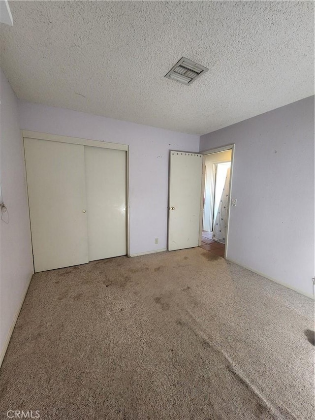 2763 US Highway 111, Imperial, CA 92251 - unfurnished bedroom featuring carpet flooring, a textured ceiling, and a closet