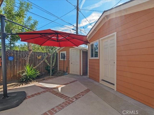 view of patio / terrace featuring a storage unit