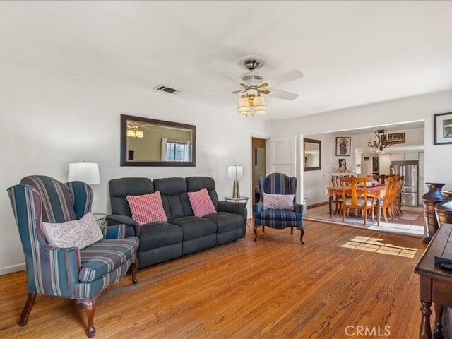 living room with hardwood / wood-style floors and ceiling fan