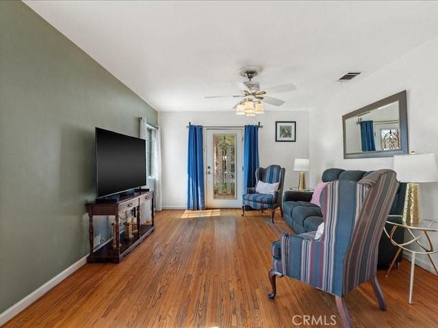 living room with hardwood / wood-style floors and ceiling fan