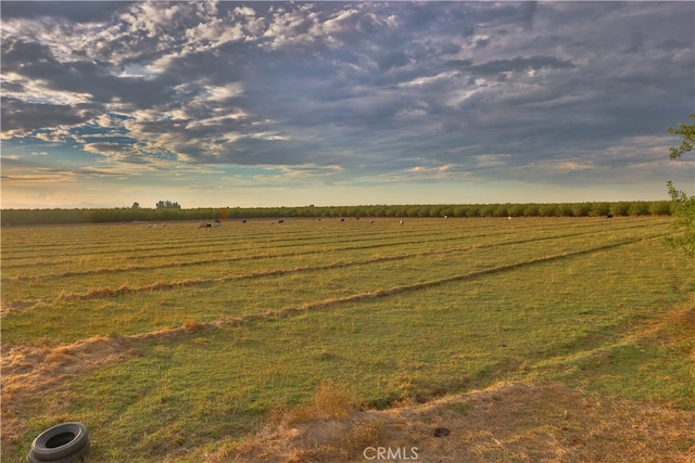 nature at dusk featuring a rural view