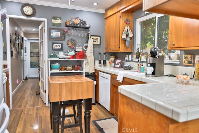 kitchen with tile countertops, crown molding, dark hardwood / wood-style floors, and white dishwasher