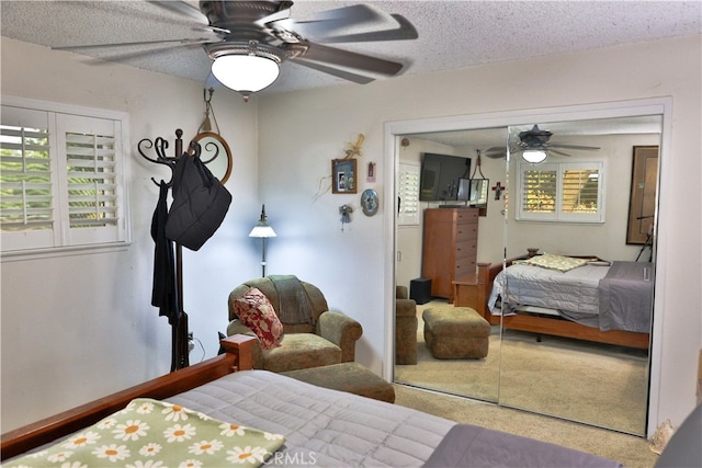 bedroom with a textured ceiling, a closet, and ceiling fan