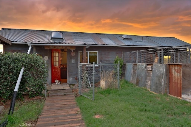 view of front facade featuring fence and metal roof