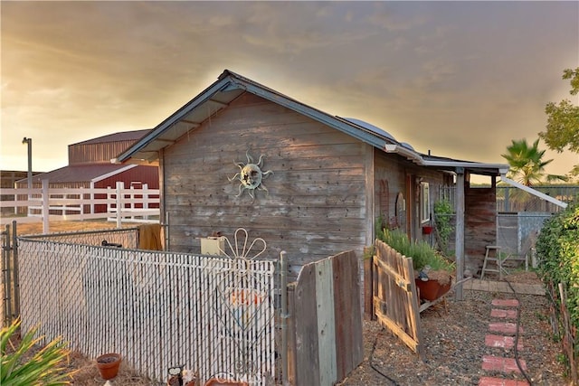 view of side of home featuring fence