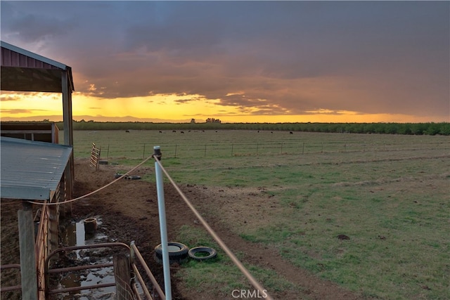 yard at dusk with a rural view