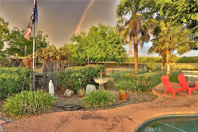 view of yard featuring fence and a patio