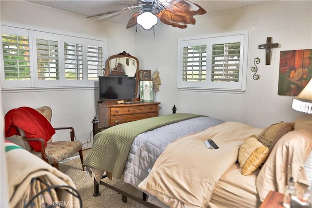 carpeted bedroom with a ceiling fan