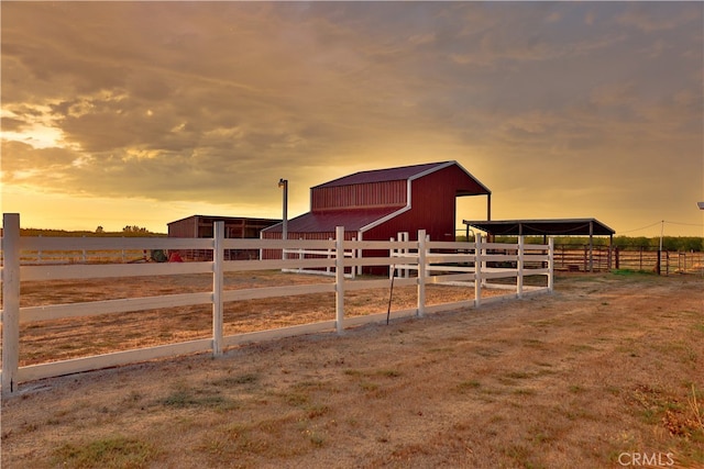 view of stable featuring a rural view