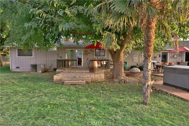 back of property with a patio area, central AC, a yard, and a deck