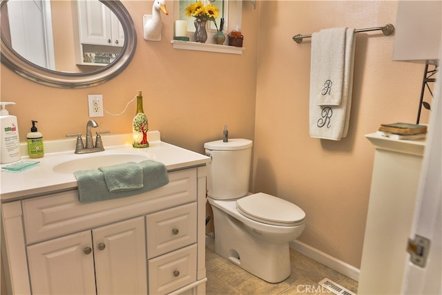 bathroom with vanity, toilet, and tile patterned flooring