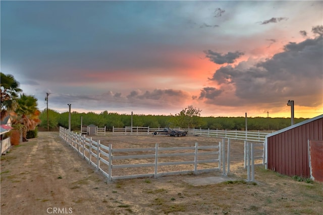 yard at dusk with a rural view