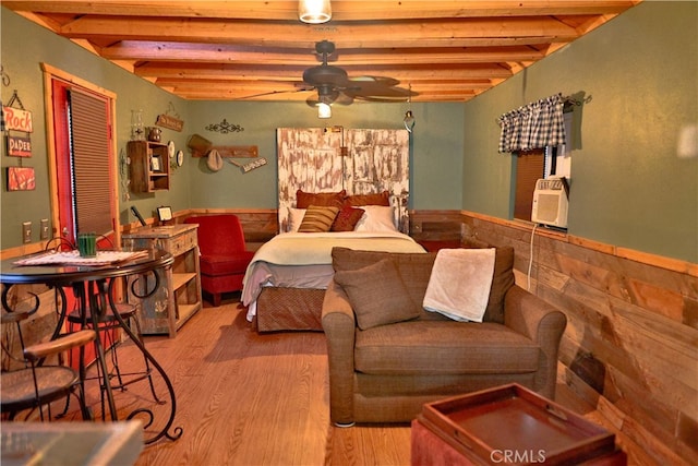 bedroom with beam ceiling and wood-type flooring