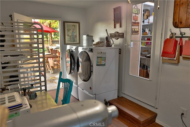 laundry area featuring independent washer and dryer and hardwood / wood-style flooring