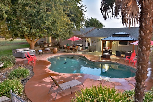 view of swimming pool with a jacuzzi, a patio area, and area for grilling