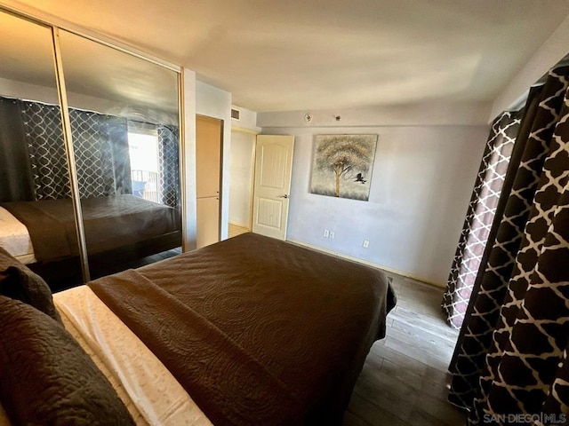 bedroom featuring hardwood / wood-style flooring and a closet