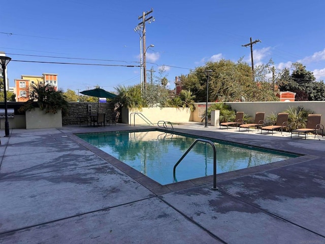 view of swimming pool with a patio