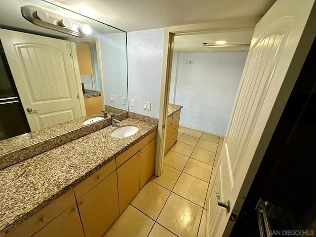 bathroom featuring tile patterned flooring and vanity