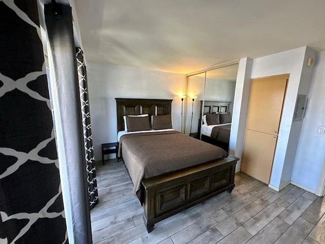 bedroom with light wood-type flooring and a closet