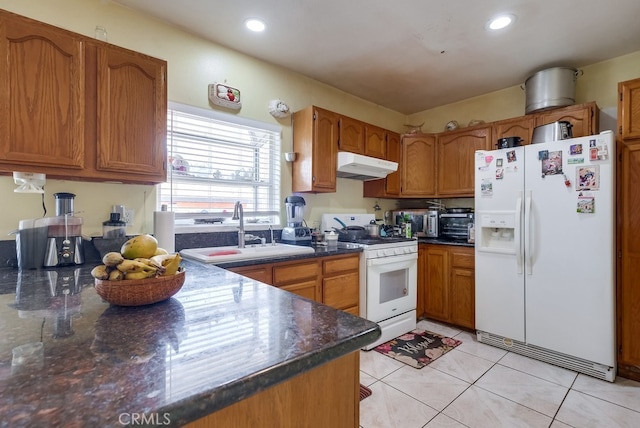 kitchen featuring white appliances, sink, and light tile patterned floors