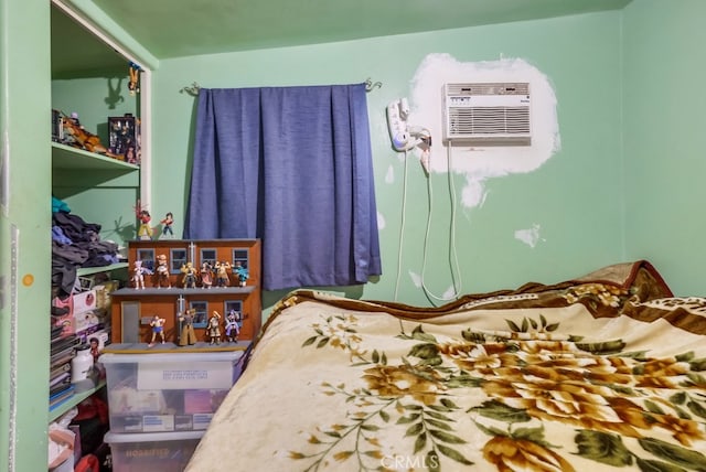 bedroom featuring an AC wall unit