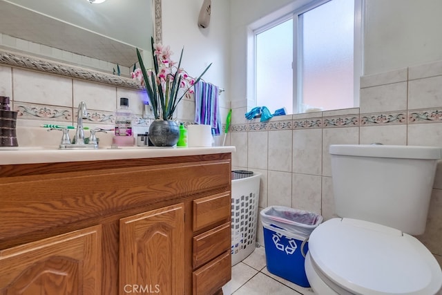 bathroom with tile walls, tile patterned flooring, vanity, and toilet