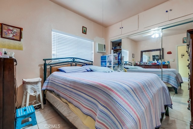 bedroom featuring light tile patterned floors and a closet