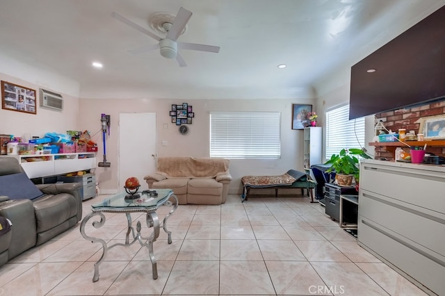 living room featuring light tile patterned floors, an AC wall unit, and ceiling fan