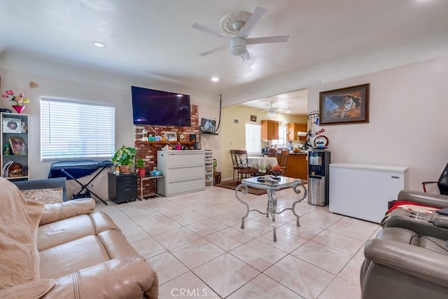 tiled living room featuring a healthy amount of sunlight and ceiling fan