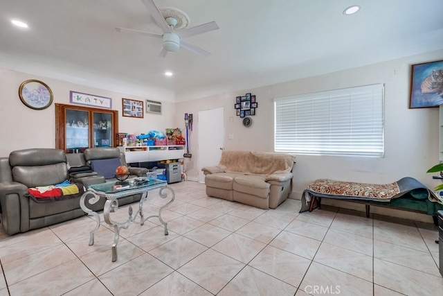 tiled living room with an AC wall unit and ceiling fan