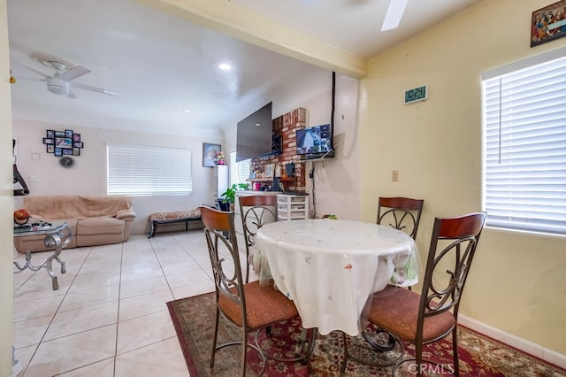 dining space featuring ceiling fan and light tile patterned floors