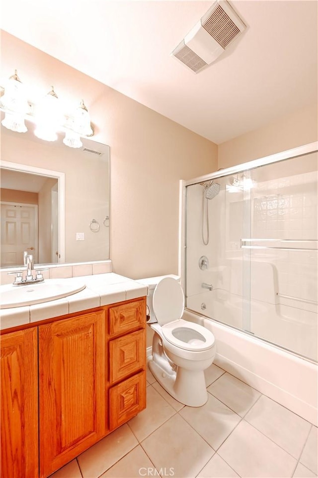 full bathroom featuring enclosed tub / shower combo, tile patterned floors, toilet, and vanity