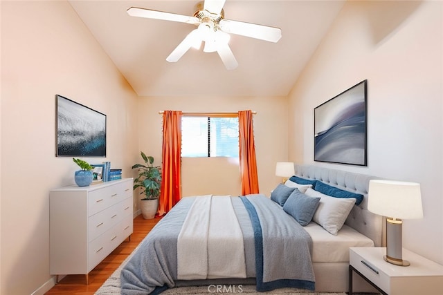 bedroom featuring ceiling fan, lofted ceiling, and light hardwood / wood-style floors