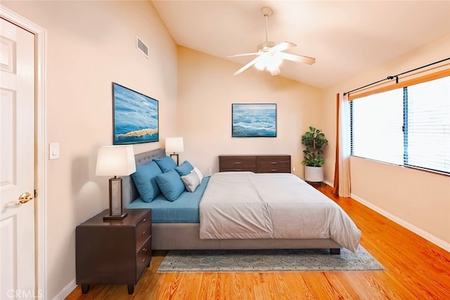 bedroom featuring hardwood / wood-style flooring, ceiling fan, and lofted ceiling