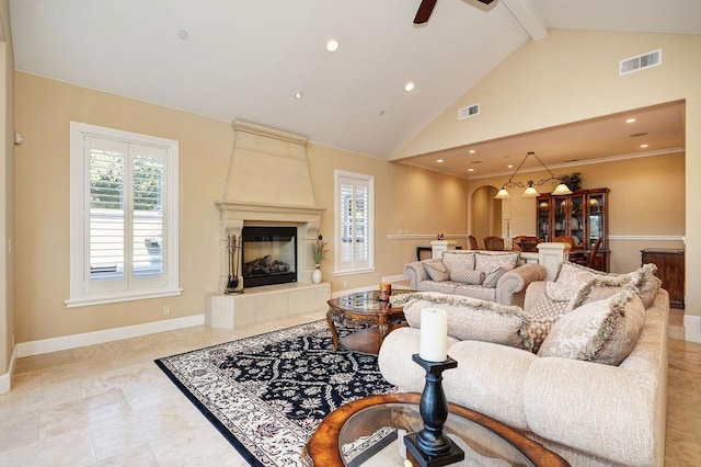 living room featuring lofted ceiling with beams, ceiling fan, and a fireplace