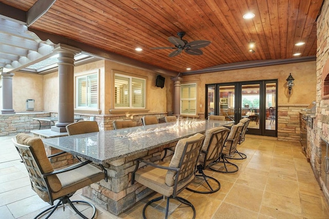 view of patio featuring an outdoor bar and ceiling fan