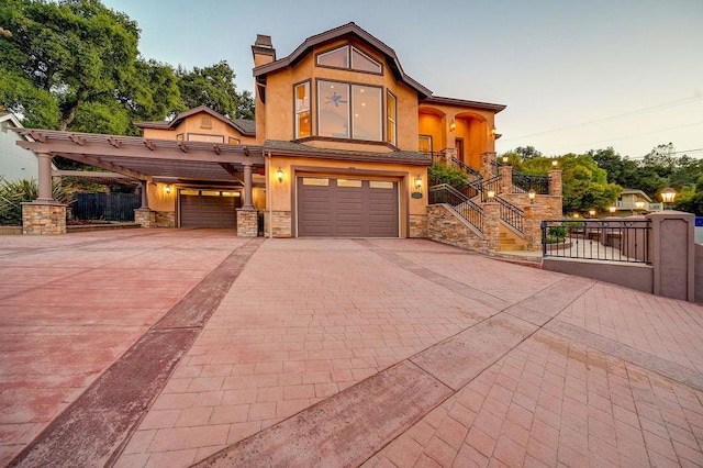 view of front of home with a carport and a garage