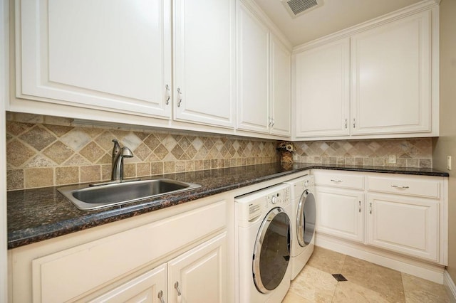 laundry area with sink, washer and clothes dryer, cabinets, and light tile patterned flooring