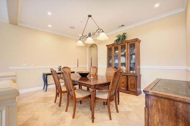 dining space featuring crown molding