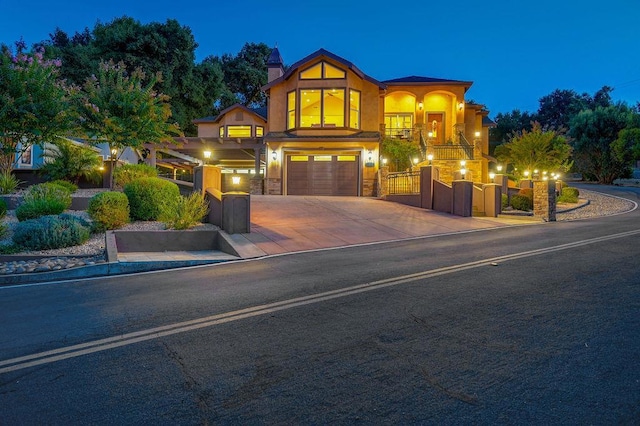 view of front of home with a garage and a balcony