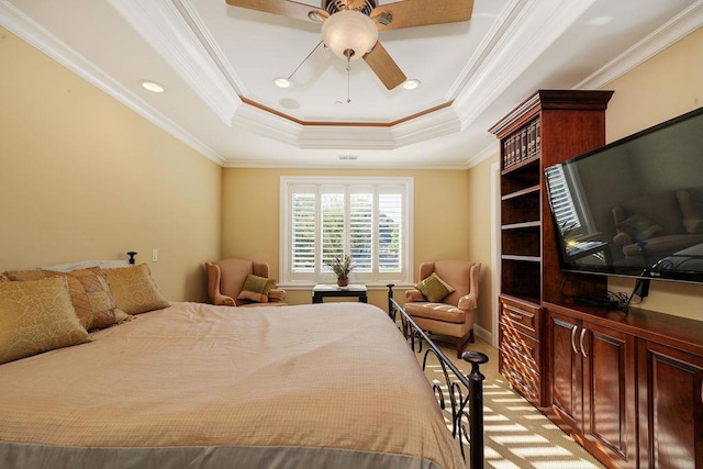 bedroom featuring a tray ceiling, ornamental molding, and ceiling fan