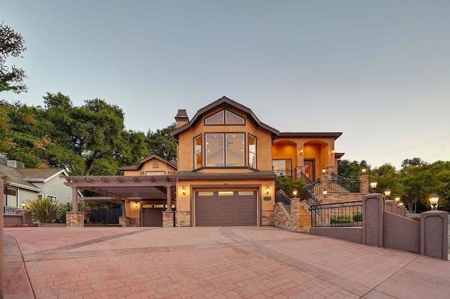 view of front of home with a garage and a carport