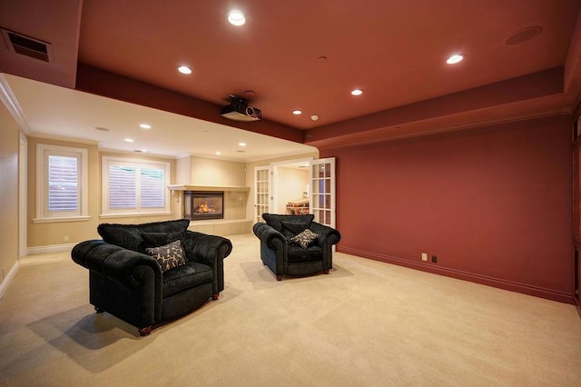 carpeted cinema with built in features and a tile fireplace