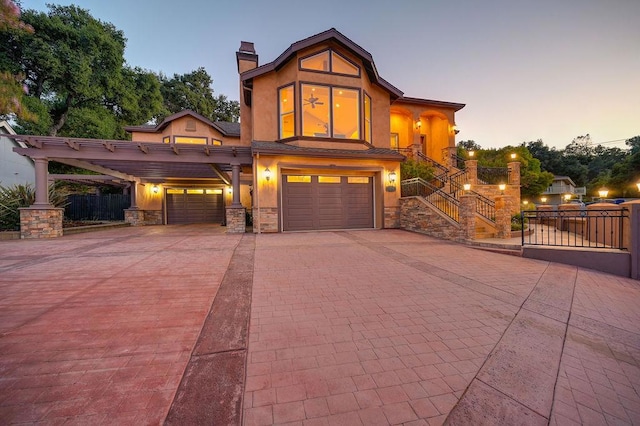 view of front of property with a garage and a carport