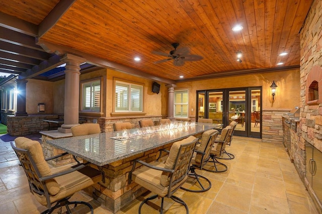 interior space featuring french doors, ceiling fan, ornamental molding, and decorative columns