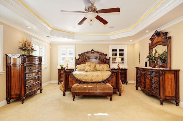 bedroom featuring crown molding, ceiling fan, a raised ceiling, and light carpet