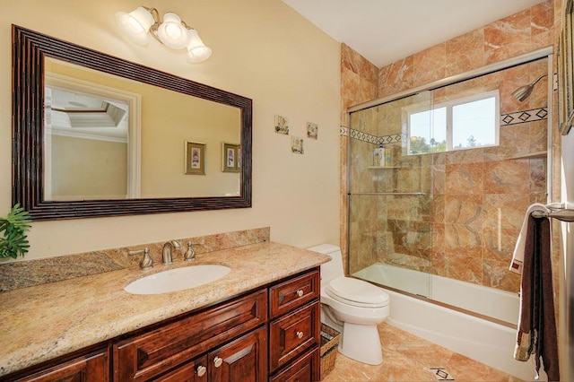 full bathroom with tile patterned flooring, bath / shower combo with glass door, vanity, and toilet