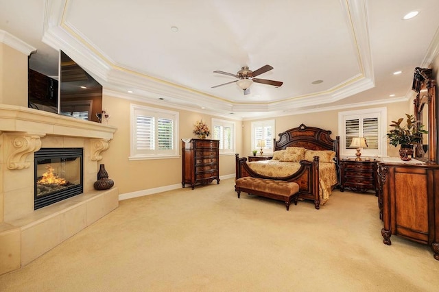 bedroom featuring crown molding, light colored carpet, and a raised ceiling